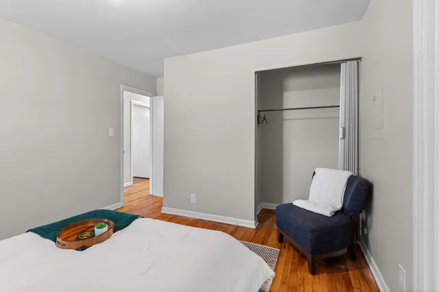 a bedroom with a bed and a chair