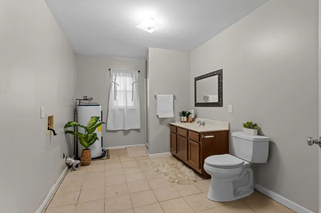 a spacious bathroom with a toilet sink and mirror