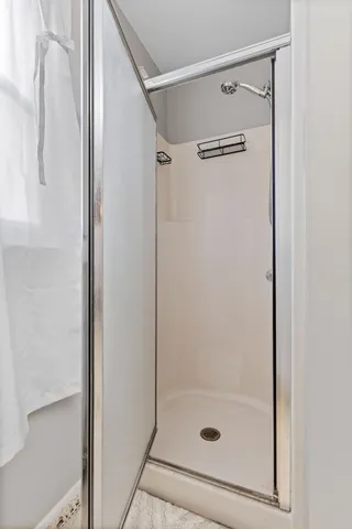 a bathroom with a glass shower door