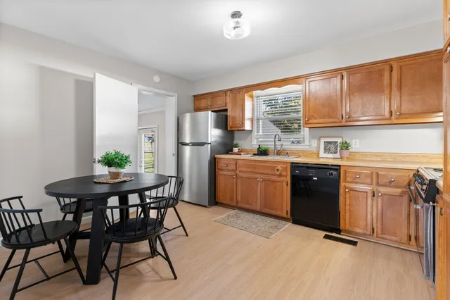 a kitchen with a stove a sink and a refrigerator