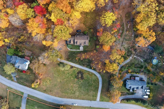 a aerial view of a house with a yard and large trees