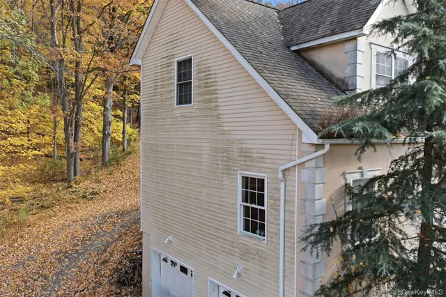 an aerial view of a house with a yard and large trees