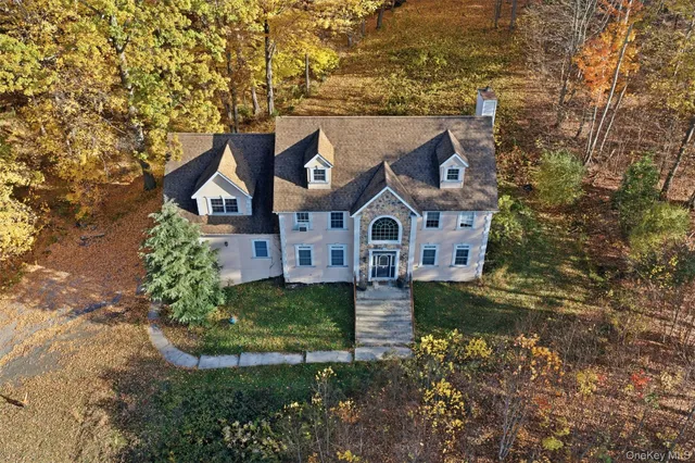 a backyard of a house with a large tree