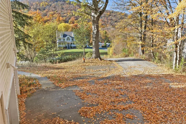 a view of a yard with wooden fence
