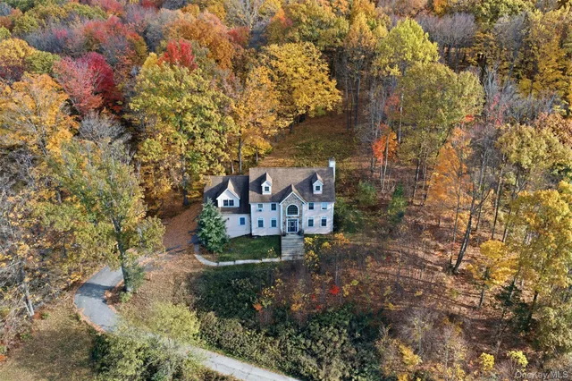 a sign board with tall trees