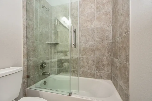 a bathroom with a bathtub and a toilet