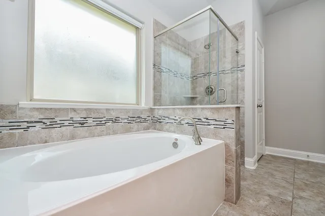a bathroom with a bathtub and shower
