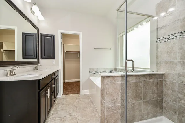 a bathroom with a double vanity sink a and a mirror