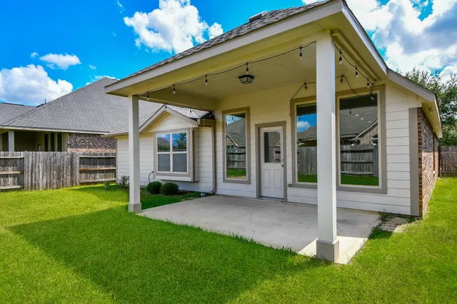 a view of a house with backyard and porch
