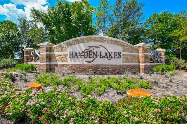 a sign board with a building in the background