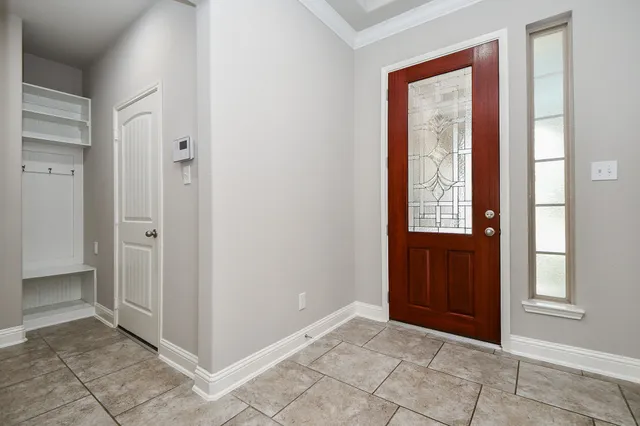 an empty room with windows and closet
