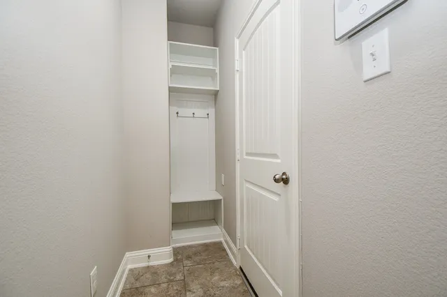 a view of a hallway with wooden floor and entryway