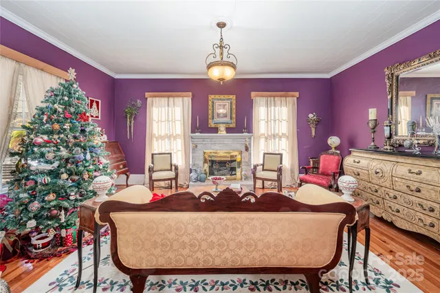 a living room with furniture a chandelier and a fireplace