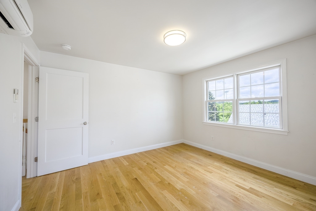 48 Spruce Street, Unit 1 Winchester, MA 01890 - Photo 21 of 29 a view of an empty room with a window