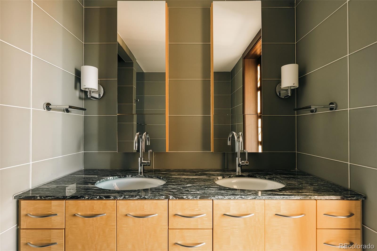 1133 14th Street, Unit 1940 Denver, CO 80202 - Photo 16 of 23 a bathroom with a granite countertop sink and a mirror