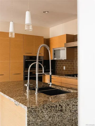 a kitchen with a sink and a stove