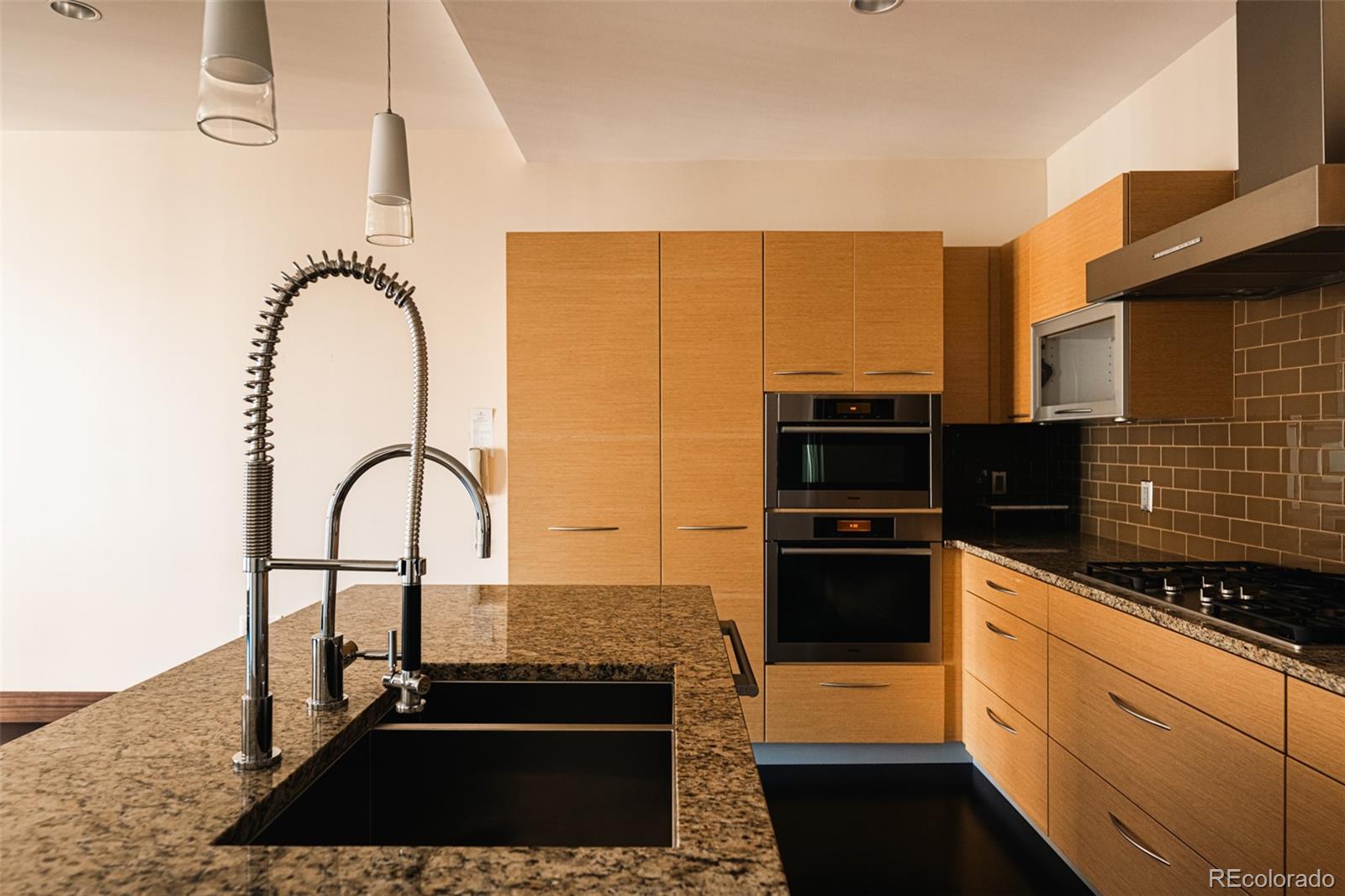 1133 14th Street, Unit 1940 Denver, CO 80202 - Photo 3 of 23 a kitchen with a sink and a stove
