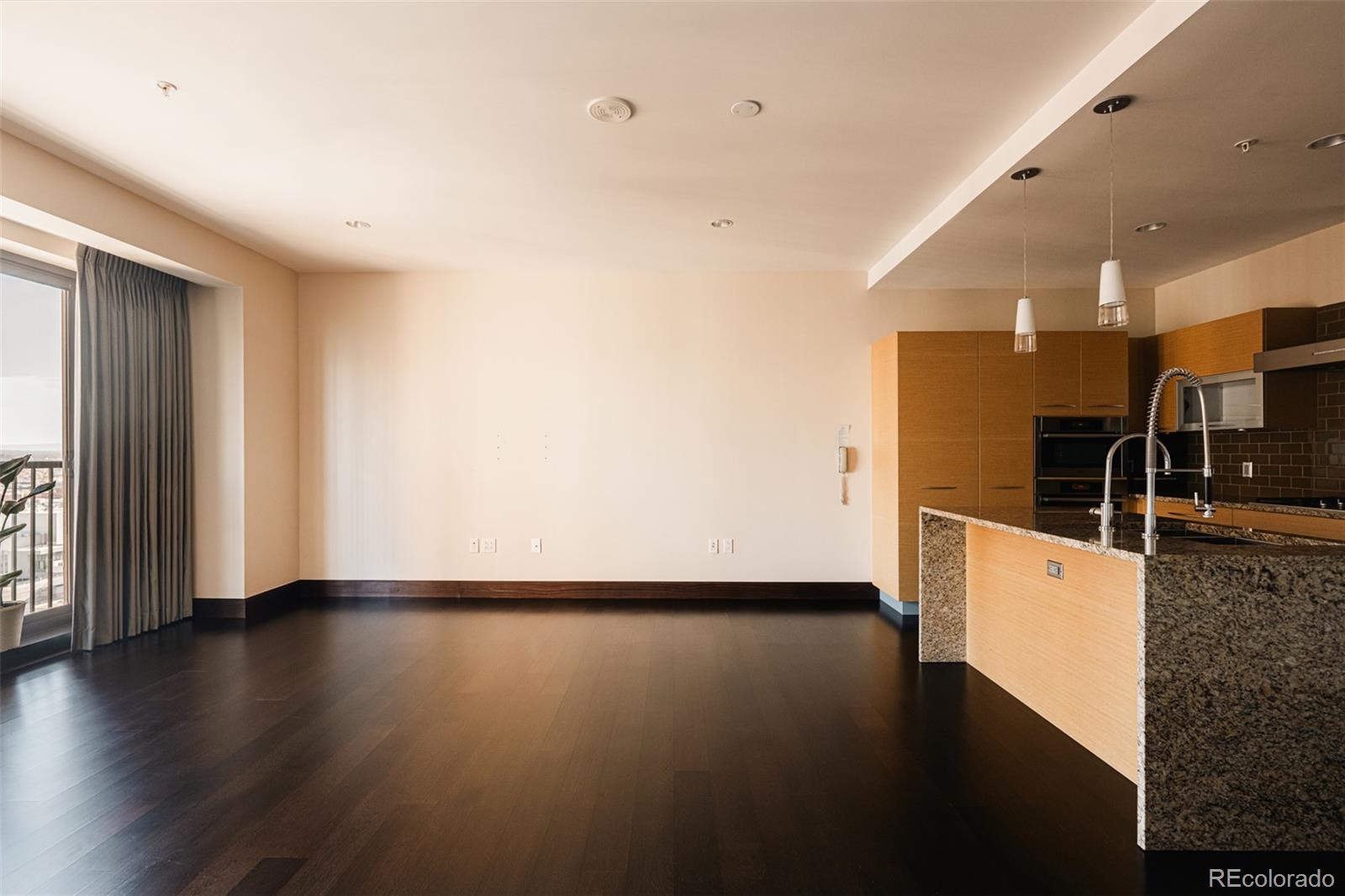 1133 14th Street, Unit 1940 Denver, CO 80202 - Photo 5 of 23 a view of a kitchen with wooden floor and electronic appliances