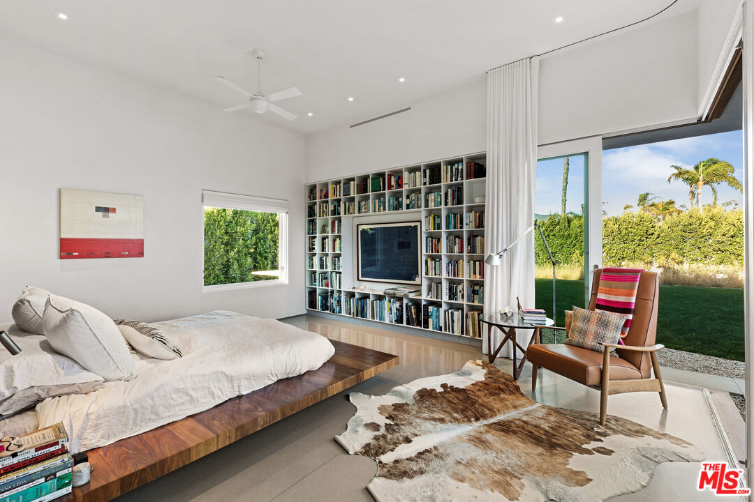 6728 Wildlife Road Malibu, CA 90265 - Photo 17 of 57 a spacious bedroom with a bed a couch and large window