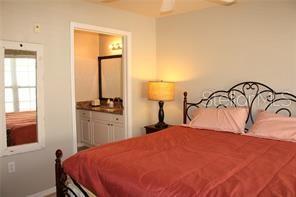 5681 Bidwell Parkway, Unit 204 Sarasota, FL 34233 - Photo 11 of 41 a bedroom with a bed and a table in it