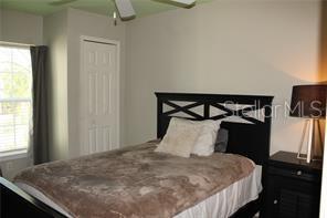 5681 Bidwell Parkway, Unit 204 Sarasota, FL 34233 - Photo 16 of 41 a bedroom with a bed and a window