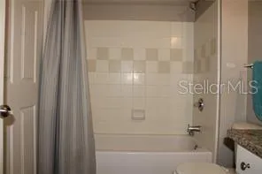 a bedroom with a bed and a lamp