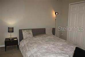 5681 Bidwell Parkway, Unit 204 Sarasota, FL 34233 - Photo 21 of 41 a bedroom with a bed and a lamp