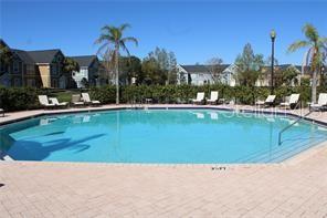 5681 Bidwell Parkway, Unit 204 Sarasota, FL 34233 - Photo 25 of 41 a view of a swimming pool and a yard