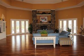 5681 Bidwell Parkway, Unit 204 Sarasota, FL 34233 - Photo 28 of 41 a view of living room with furniture wooden floor and a fireplace