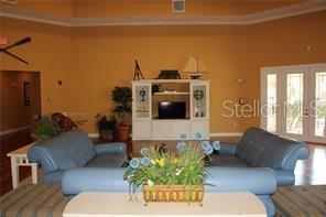 5681 Bidwell Parkway, Unit 204 Sarasota, FL 34233 - Photo 29 of 41 a living room with furniture and a flat screen tv