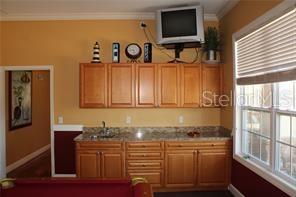 5681 Bidwell Parkway, Unit 204 Sarasota, FL 34233 - Photo 33 of 41 a bathroom with a granite countertop sink and a large mirror