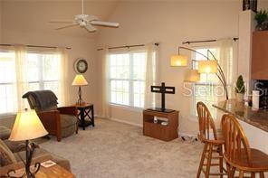 5681 Bidwell Parkway, Unit 204 Sarasota, FL 34233 - Photo 4 of 41 a living room with furniture and a large window