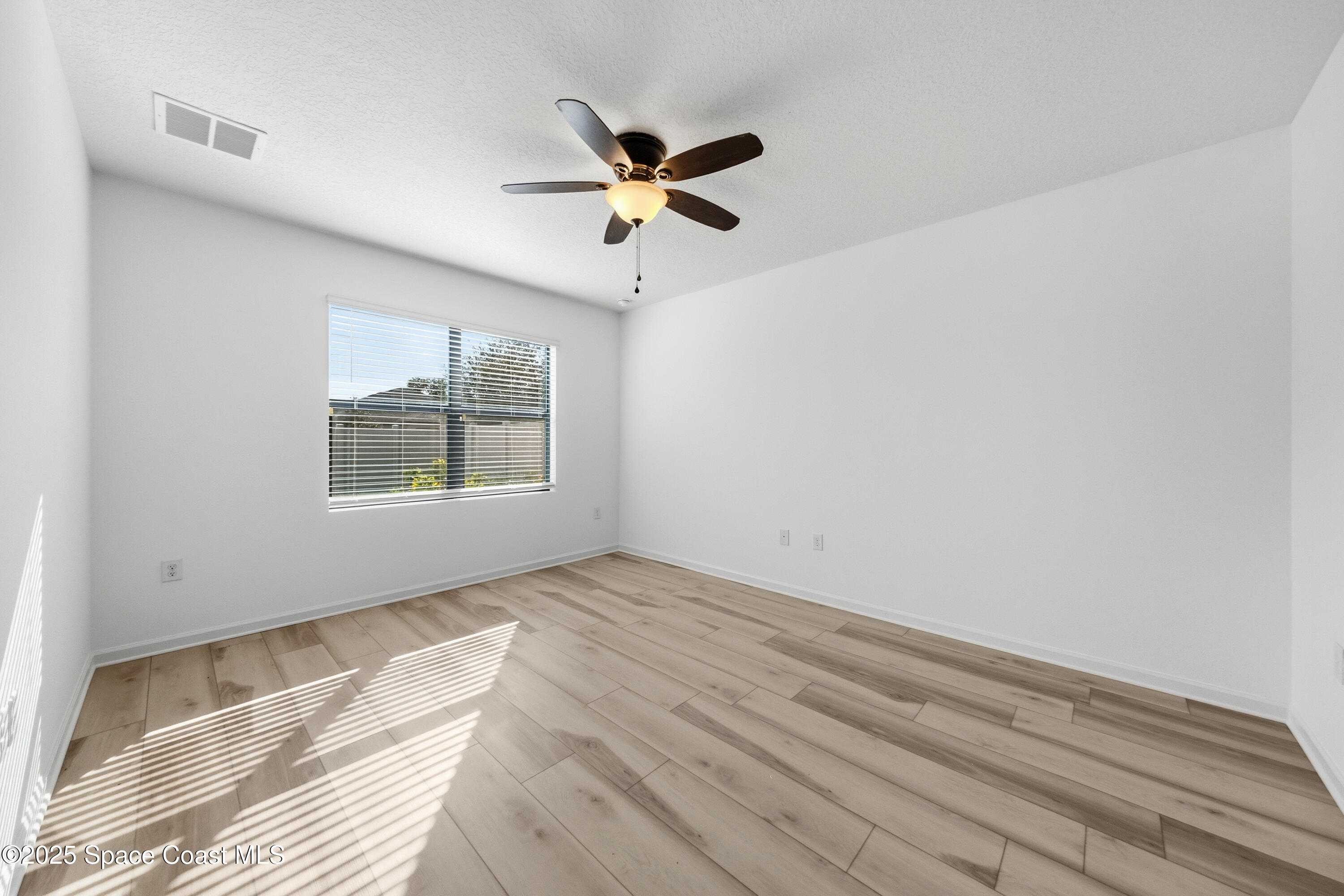 377 Snook Place Cocoa, FL 32927 - Photo 14 of 32 a view of empty room with window and ceiling fan