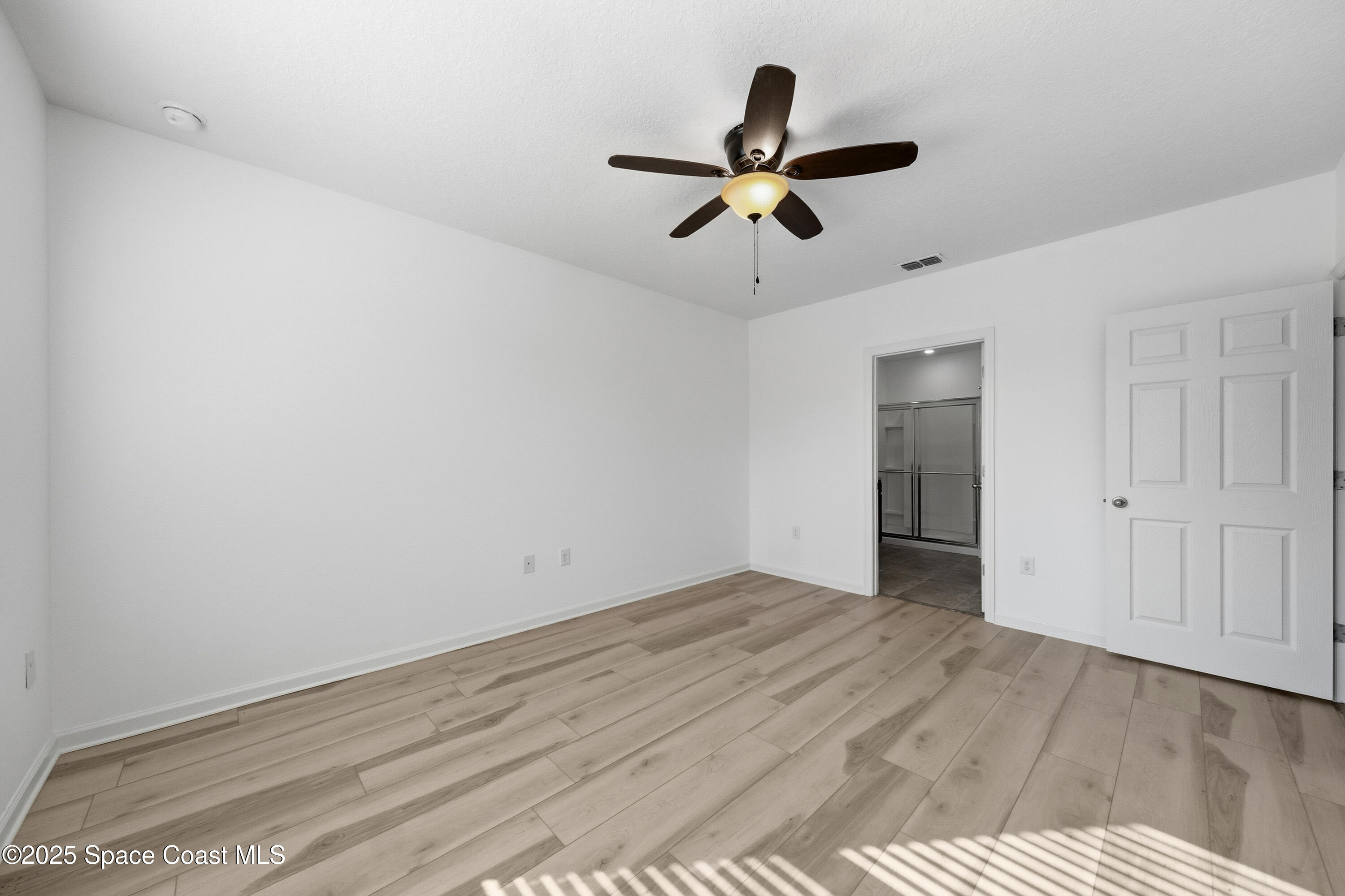 377 Snook Place Cocoa, FL 32927 - Photo 15 of 32 a view of a big room with wooden floor closet and windows