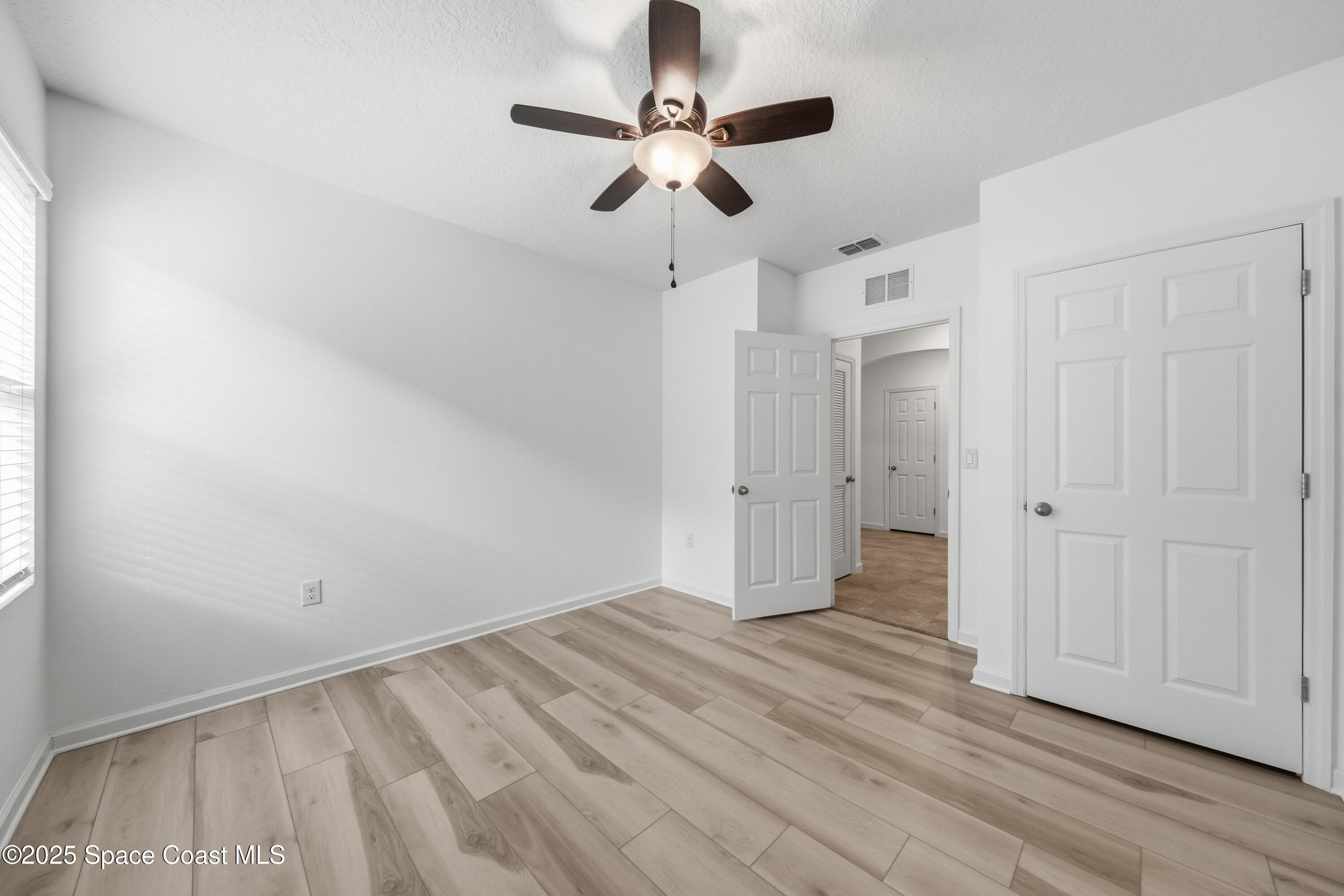 377 Snook Place Cocoa, FL 32927 - Photo 25 of 32 a view of empty room with wooden floor