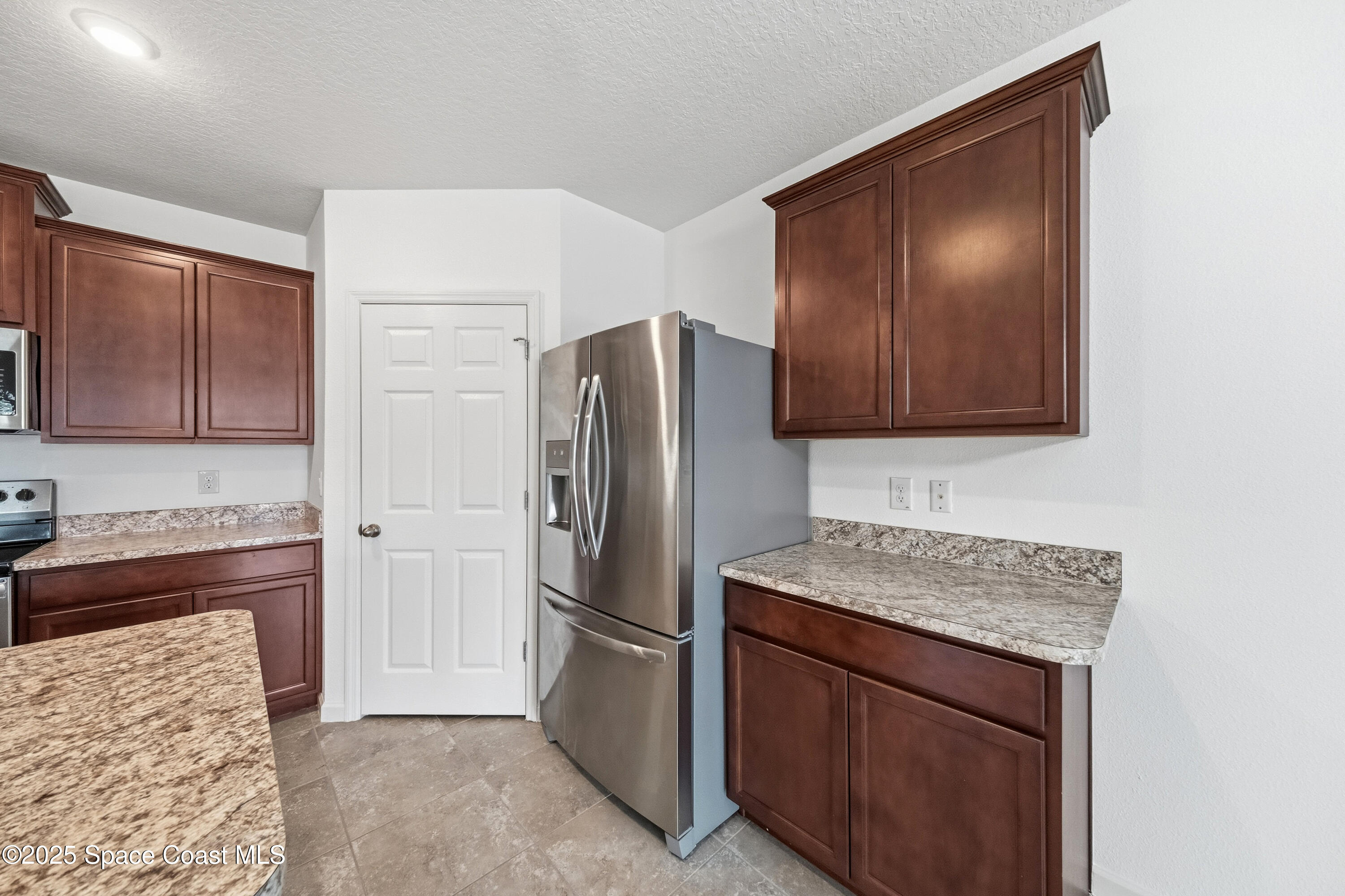 377 Snook Place Cocoa, FL 32927 - Photo 8 of 32 a kitchen with stainless steel appliances granite countertop a refrigerator and a stove top oven