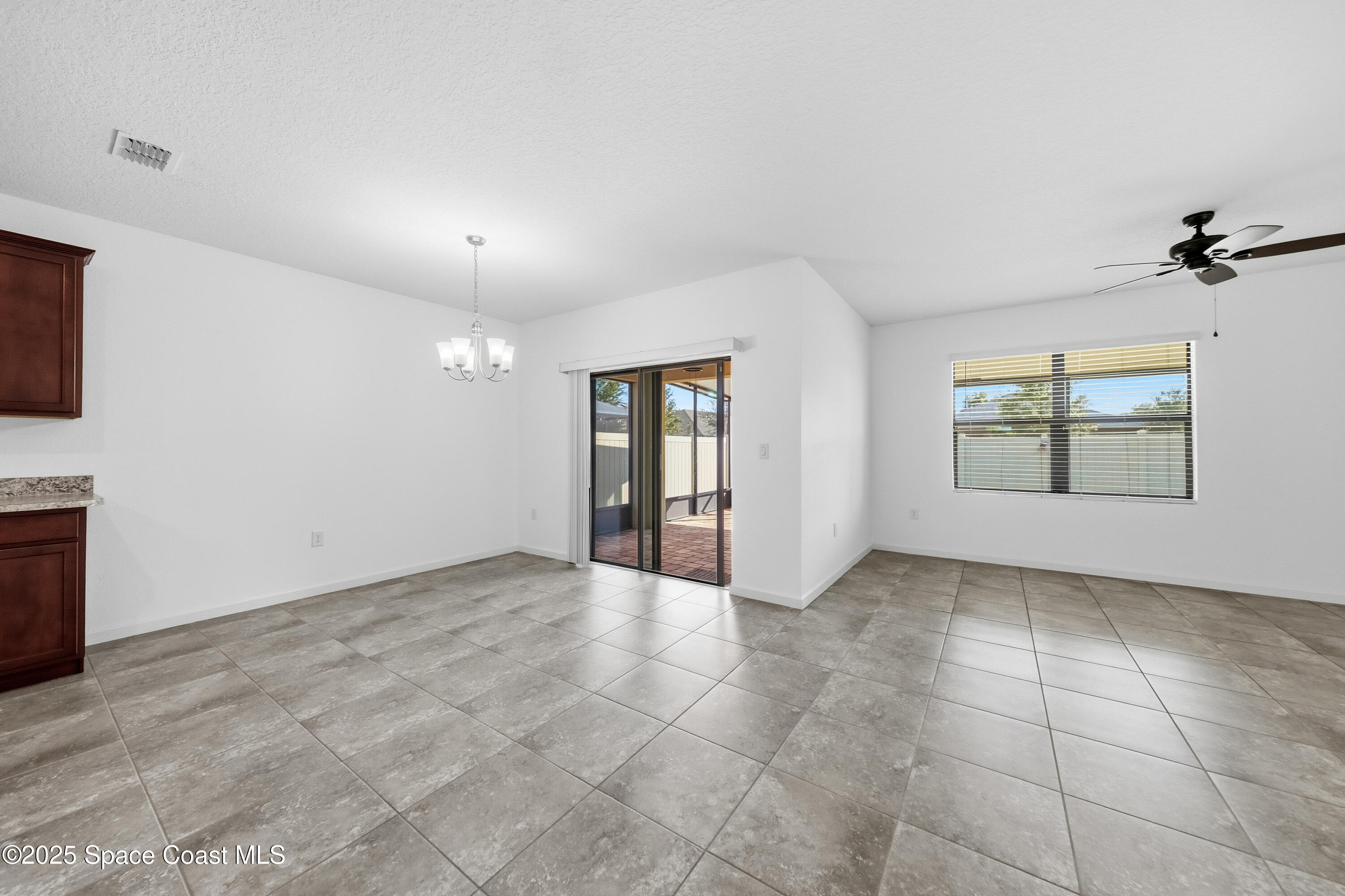 377 Snook Place Cocoa, FL 32927 - Photo 9 of 32 an empty room with windows and fireplace