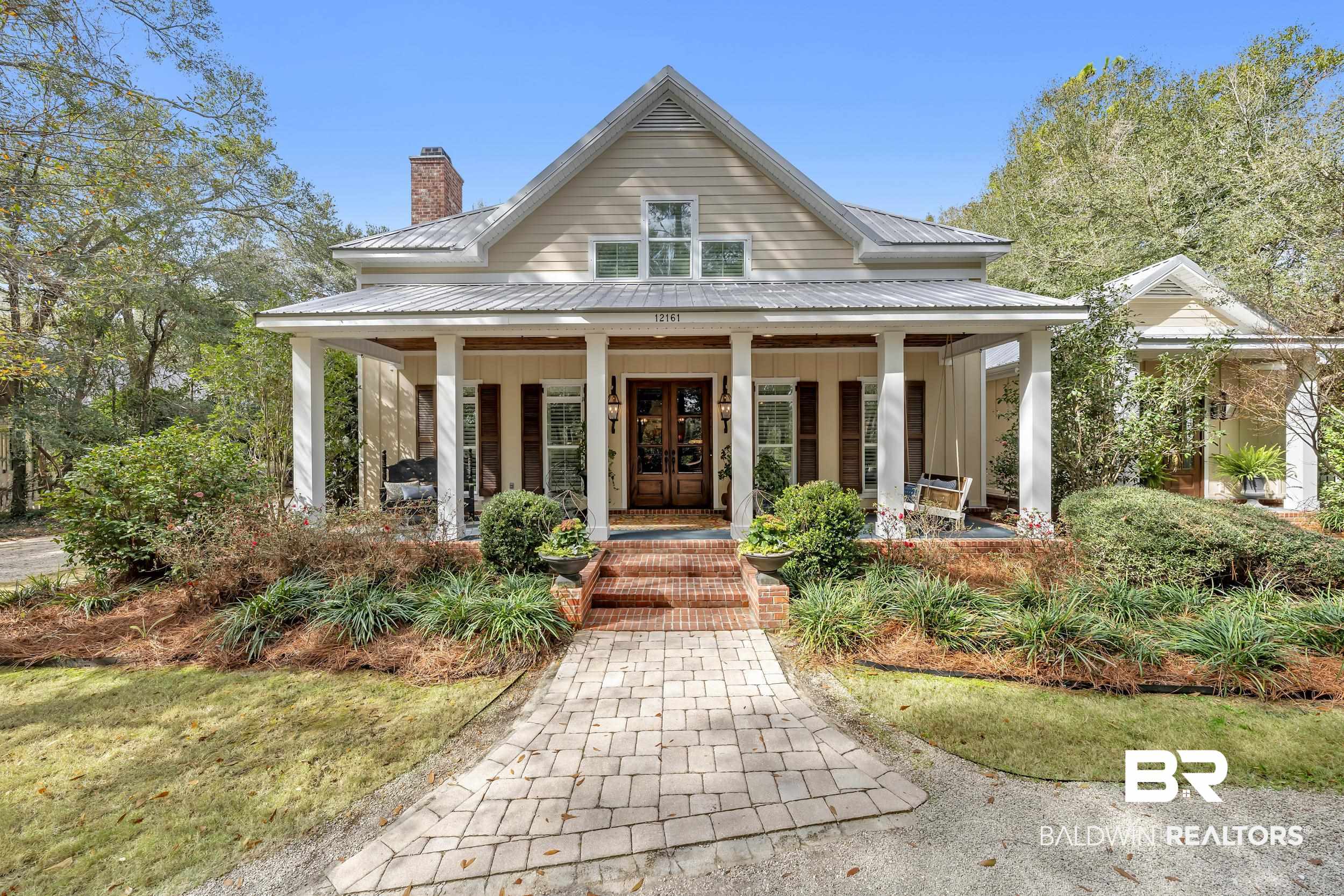 12161 Jessamine Street Magnolia Springs, AL 36555 - Photo 56 of 70 View of front of house featuring covered porch, a chimney, and a metal roof