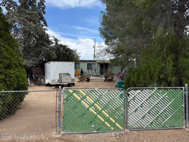 a view of a patio with table and chairs with wooden fence and plants