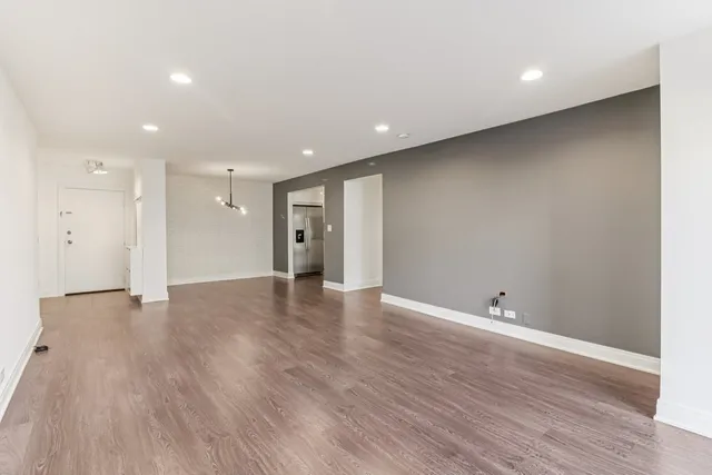 a view of living room with cabinets and a wooden floors