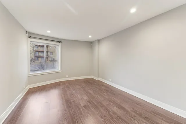 a bedroom with a large bed and a painting on the wall