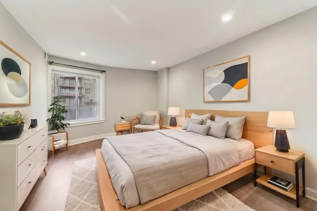 a view of an empty room with wooden floor and closet
