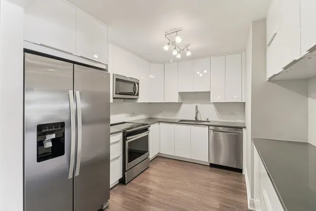 a hallway with wooden floor and electronic appliances
