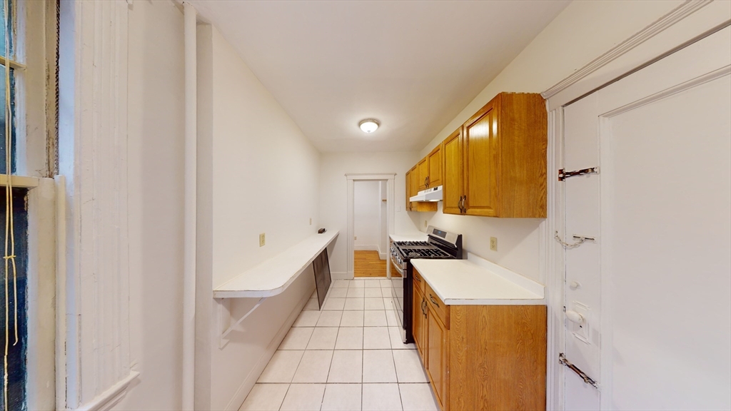 32 Sidlaw Road, Unit 7 Boston, MA 02135 - Photo 3 of 10 a bathroom with a sink a mirror and a bathtub