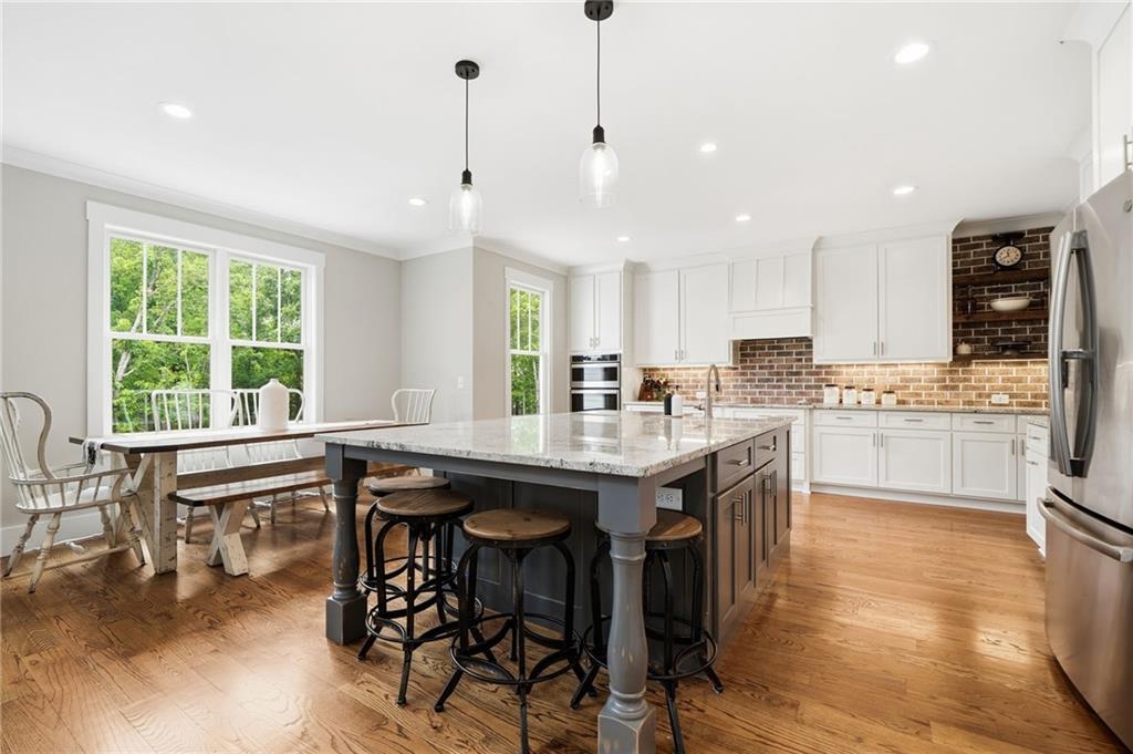 180 Laurel Ridge Lane Ball Ground, GA 30107 - Photo 14 of 71 a kitchen with granite countertop counter space dining table and stainless steel appliances