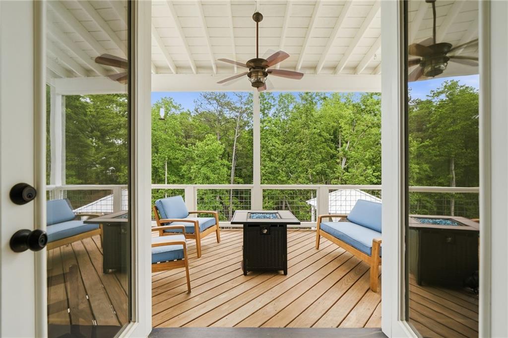 180 Laurel Ridge Lane Ball Ground, GA 30107 - Photo 54 of 71 a view of a living room and floor to ceiling windows