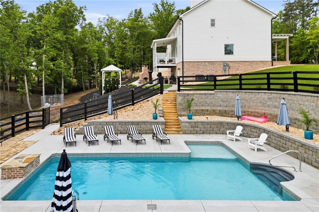 180 Laurel Ridge Lane Ball Ground, GA 30107 - Photo 61 of 71 a view of swimming pool with a patio
