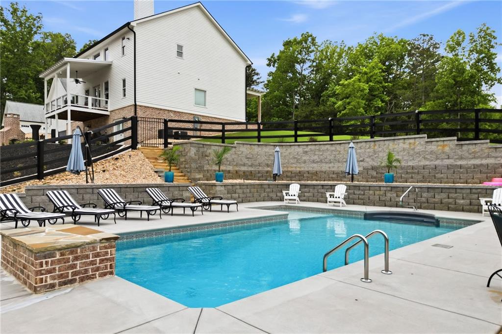180 Laurel Ridge Lane Ball Ground, GA 30107 - Photo 65 of 71 a view of a chairs and table on the terrace