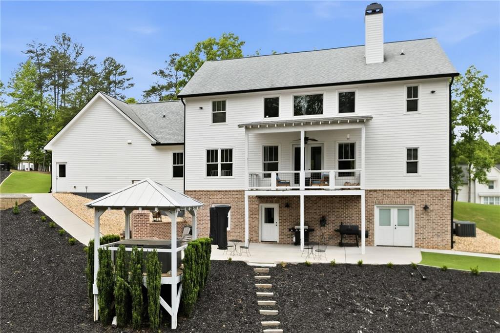 180 Laurel Ridge Lane Ball Ground, GA 30107 - Photo 66 of 71 a view of a white house with large windows