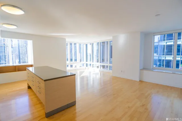 a living room with furniture and large windows